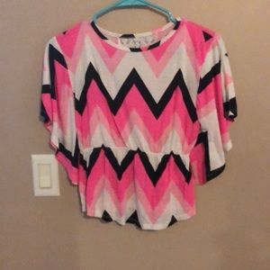 A pink, black, and white blouse